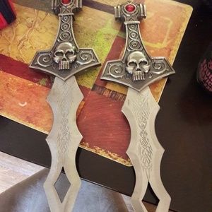 Two skull knifes with the wooden frames